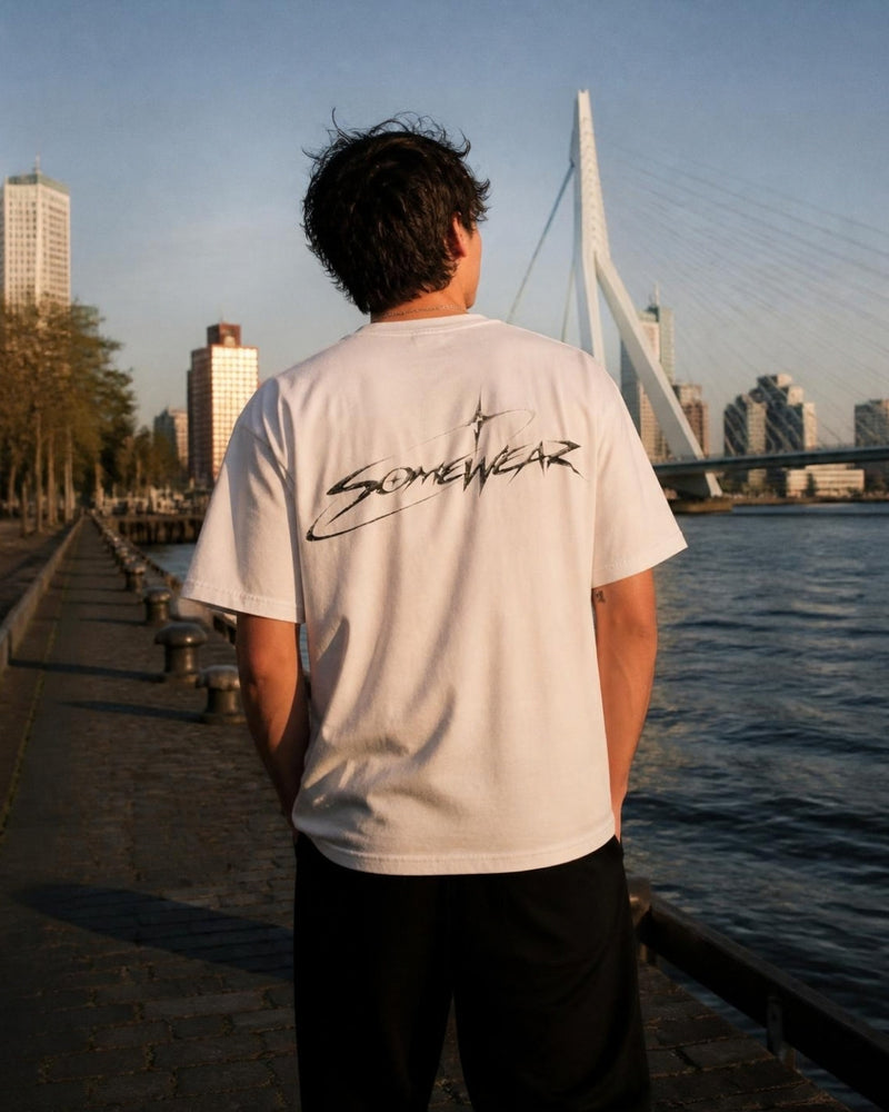 Somewear white tee with the script back logo, Rotterdam waterfront at golden hour