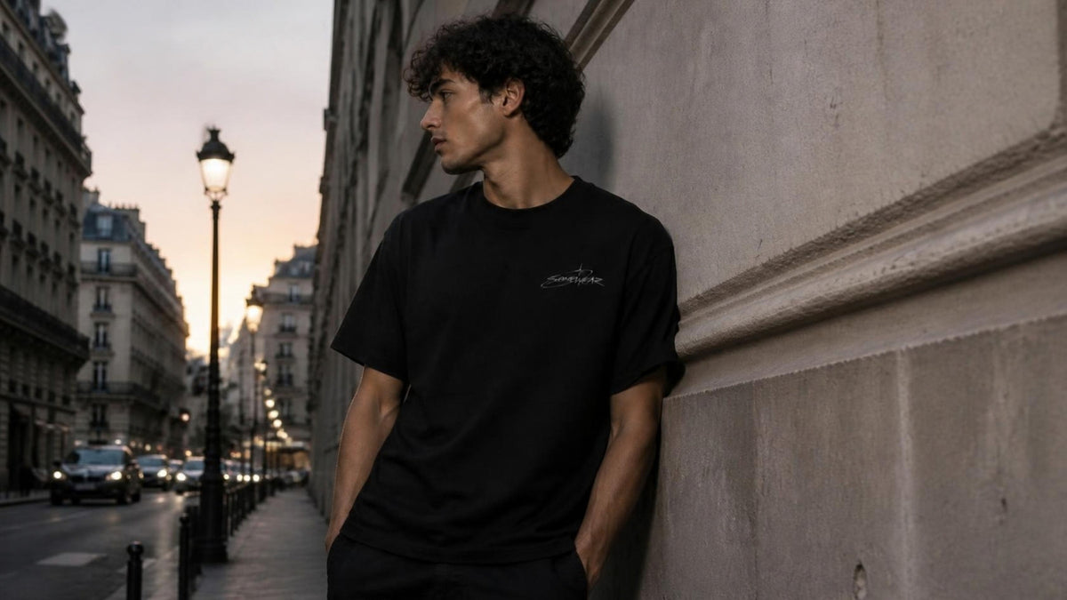 Black Somewear logo tee on a city street at dusk